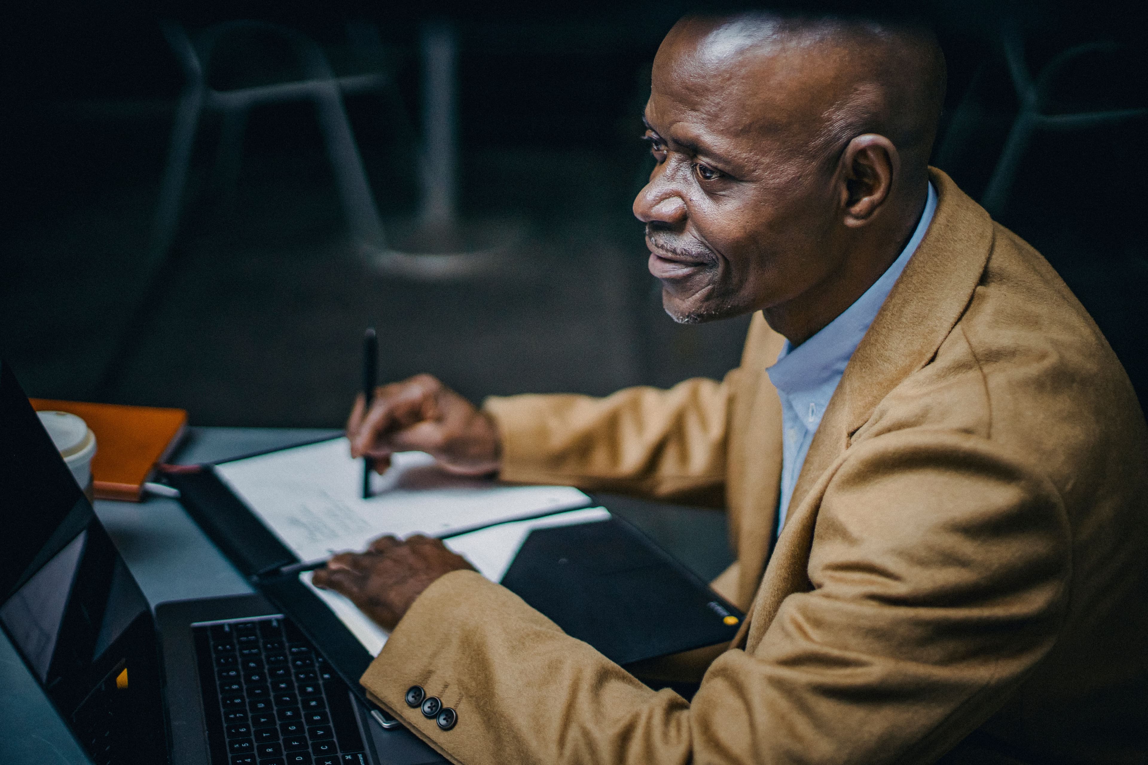 Founder reviewing business notes with a laptop